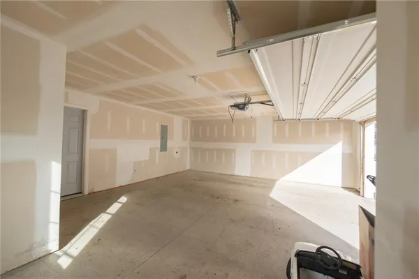 a view of a big room with staircase and door