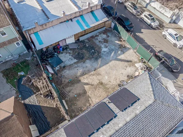an aerial view of a house with a yard