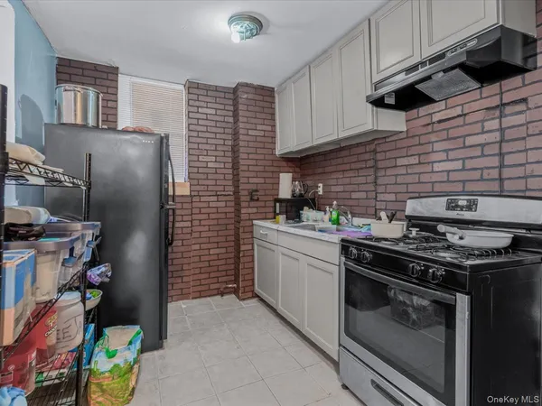 a kitchen with stainless steel appliances granite countertop a stove and a refrigerator