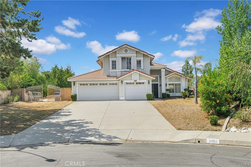 1057 Bay Ridge Circle Riverside, CA 92506 - Photo 1 of 1 a front view of a house with a yard and garage