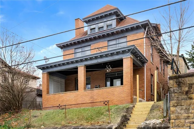 a view of a building with a small yard