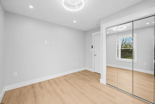 a view of hallway with wooden floor