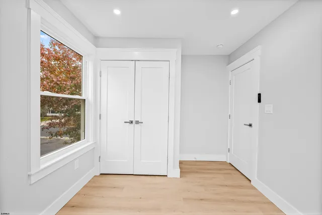 a bathroom with a toilet a sink a vanity and window