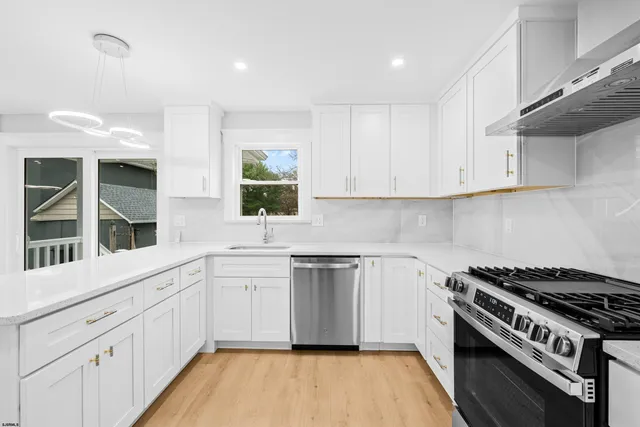 a kitchen with stainless steel appliances granite countertop a stove and a sink