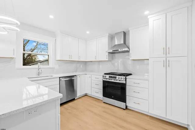 a kitchen with stainless steel appliances granite countertop a stove and a sink