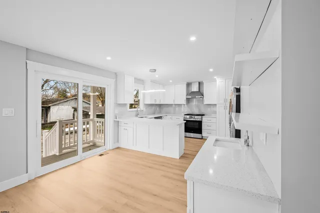a view of kitchen with wooden floor and windows
