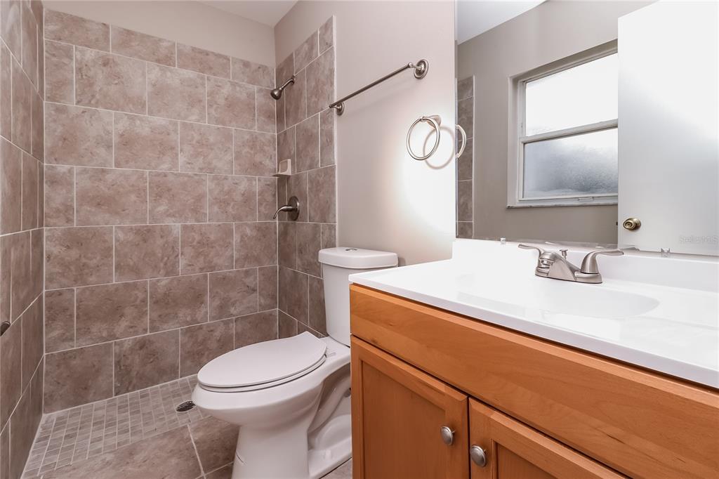 605 Dorothy Circle Eustis, FL 32726 - Photo 8 of 15 a bathroom with a sink a toilet and shower