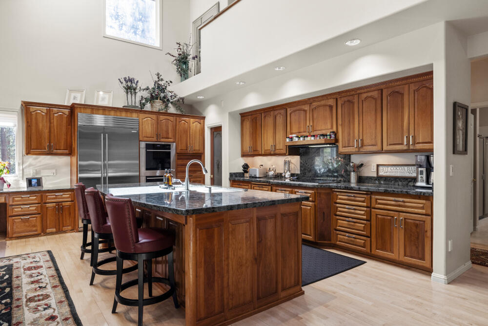 11629 Merganser Road Klamath Falls, OR 97601 - Photo 15 of 50 a kitchen with stainless steel appliances granite countertop a stove top oven a sink dishwasher and cabinets with wooden floor