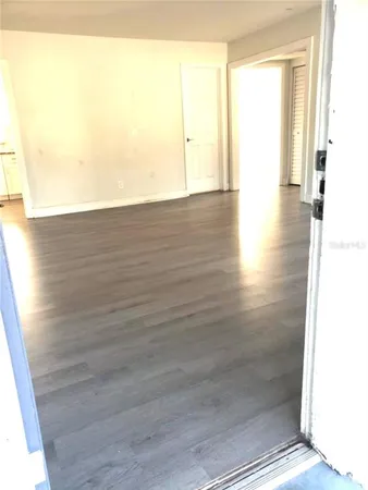a view of a room with wooden floor and brick walls