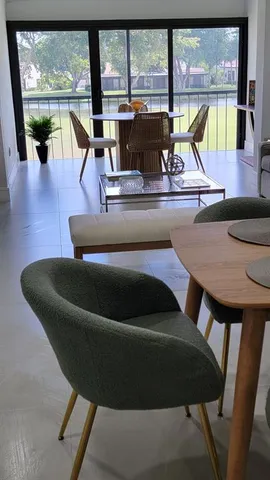 a living room with furniture and a floor to ceiling window