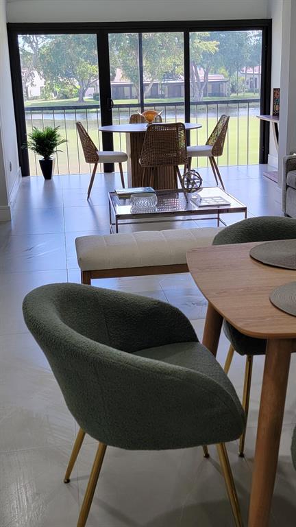 a living room with furniture and a floor to ceiling window