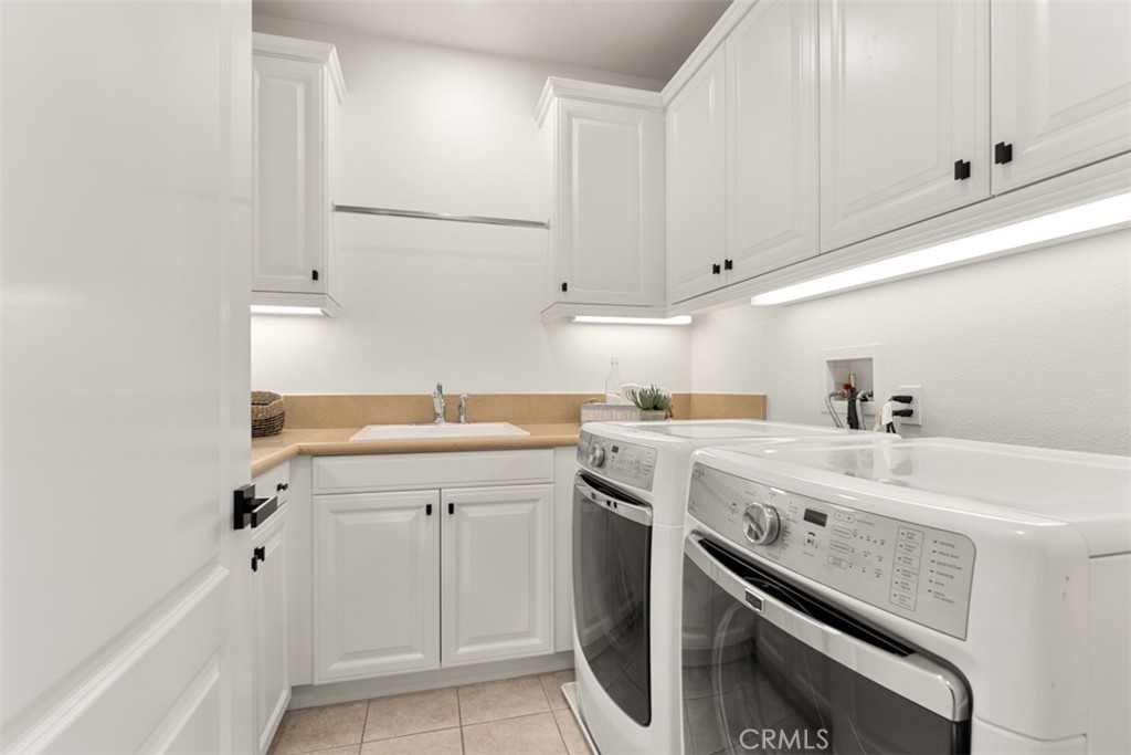 21 Via Nerisa San Clemente, CA 92673 - Photo 26 of 54 a utility room with cabinets washer and dryer