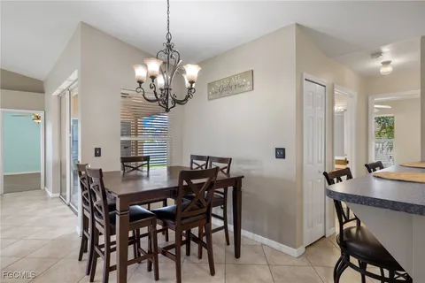 a view of a dining room with furniture and chandelier