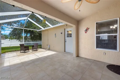 a backyard of a house with fountain table and chairs