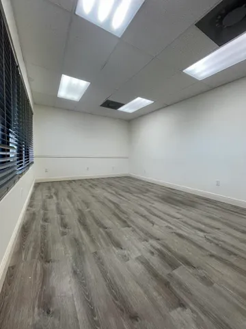 a view of a room with wooden floor