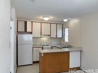 927 Spencer Street, Unit A1 Honolulu, HI 96822 - Photo 5 of 13 a kitchen with stainless steel appliances granite countertop a refrigerator sink and cabinets