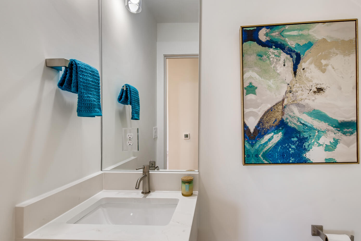 505 Kemp Street Austin, TX 78741 - Photo 13 of 34 A sleek guest half bath with clean finishes and a little pop of style.
