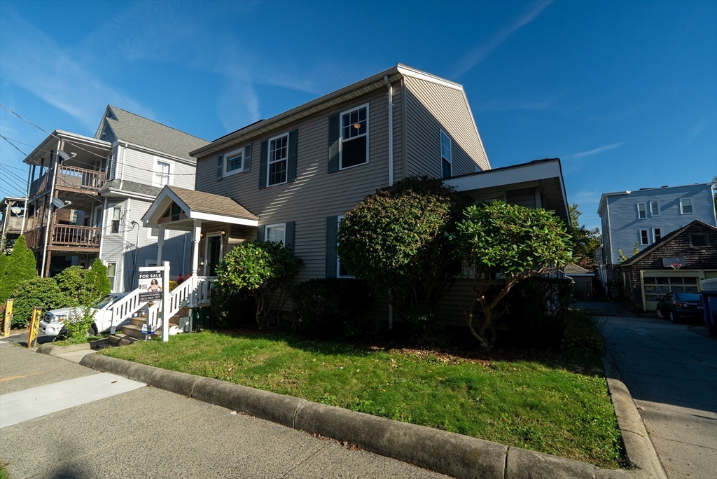 a front view of a house with a yard