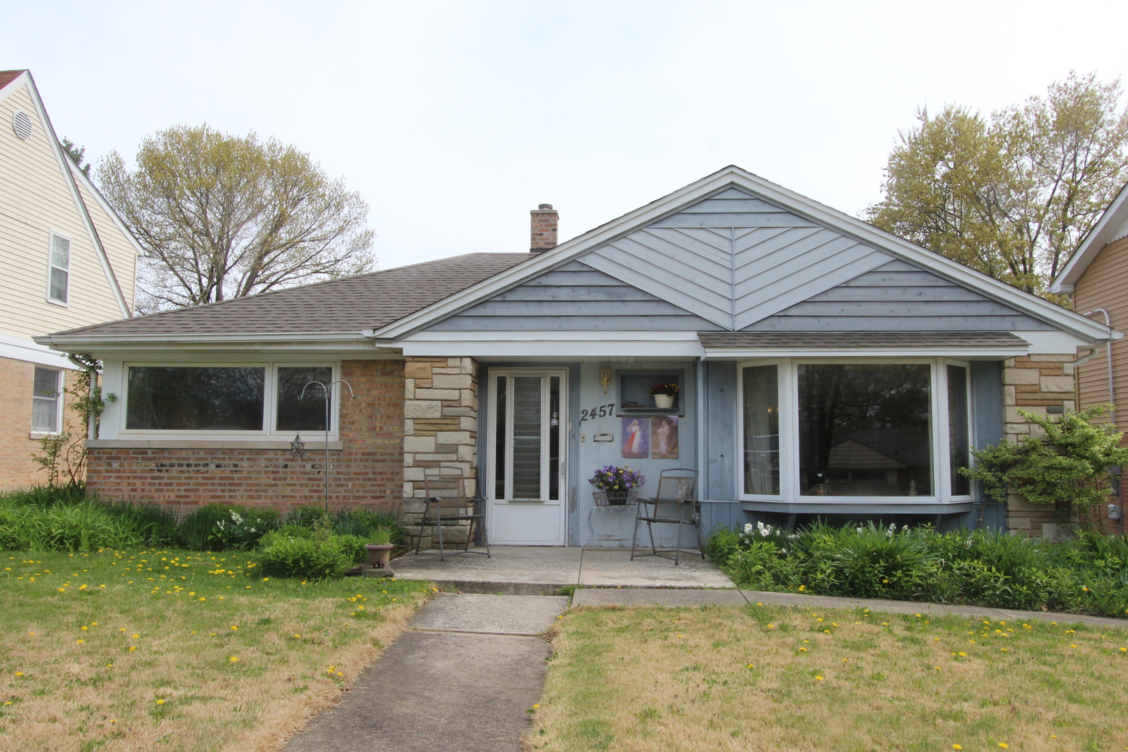 2457 Hawthorne Road Homewood, IL 60430 - Photo 1 of 20 a front view of a house with garden