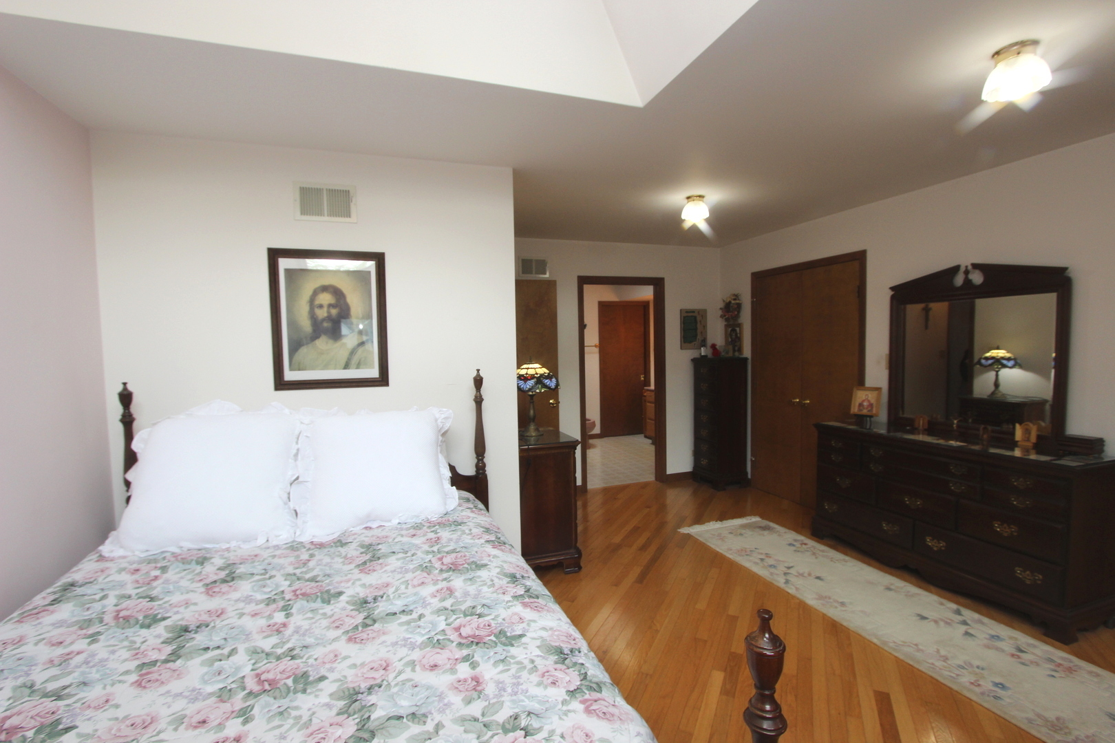 2457 Hawthorne Road Homewood, IL 60430 - Photo 11 of 20 a bedroom with a bed and a bathroom with mirror