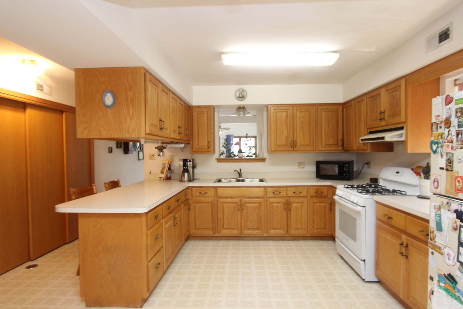 2457 Hawthorne Road Homewood, IL 60430 - Photo 6 of 20 a kitchen with stainless steel appliances a sink stove and cabinets