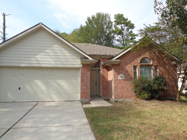 17136 Gleneagle Drive South Conroe, TX 77385 - Photo 1 of 19 a front view of a house with a yard and garage