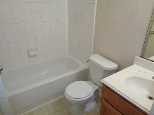 17136 Gleneagle Drive South Conroe, TX 77385 - Photo 14 of 19 a white toilet sitting next to a bath tub