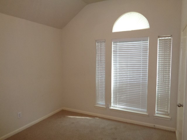 17136 Gleneagle Drive South Conroe, TX 77385 - Photo 15 of 19 an empty room with a window