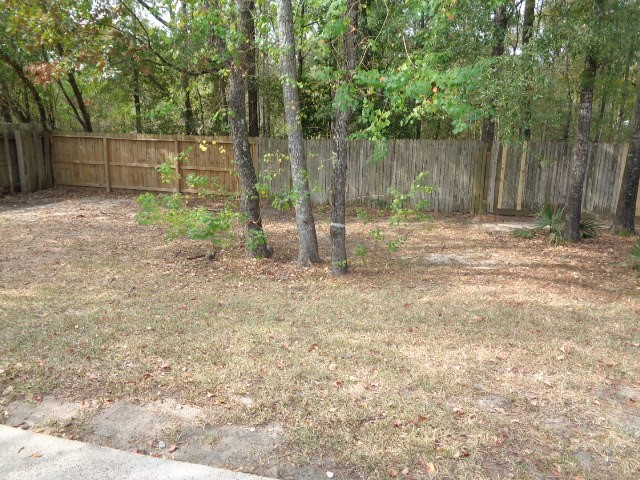17136 Gleneagle Drive South Conroe, TX 77385 - Photo 18 of 19 a backyard of a house with lots of green space
