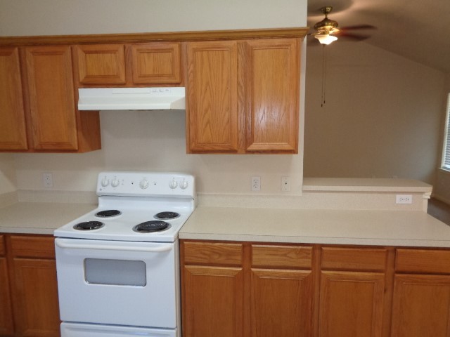 17136 Gleneagle Drive South Conroe, TX 77385 - Photo 2 of 19 a kitchen with a cabinets and white stove