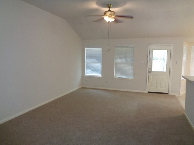 17136 Gleneagle Drive South Conroe, TX 77385 - Photo 6 of 19 an empty room with windows and fan chandelier