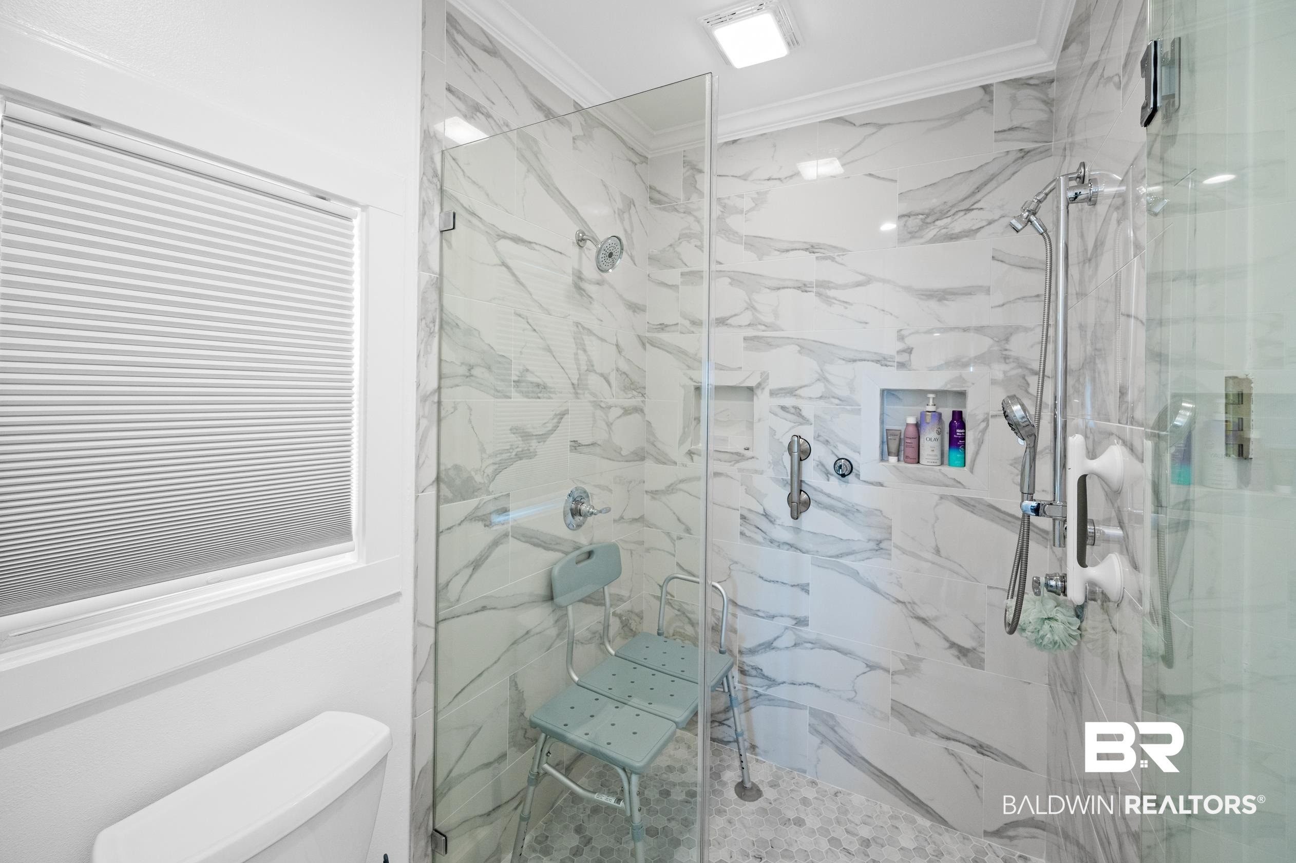 31835 River Road Orange Beach, AL 36561 - Photo 16 of 55 Bathroom featuring crown molding, toilet, and a shower with shower door
