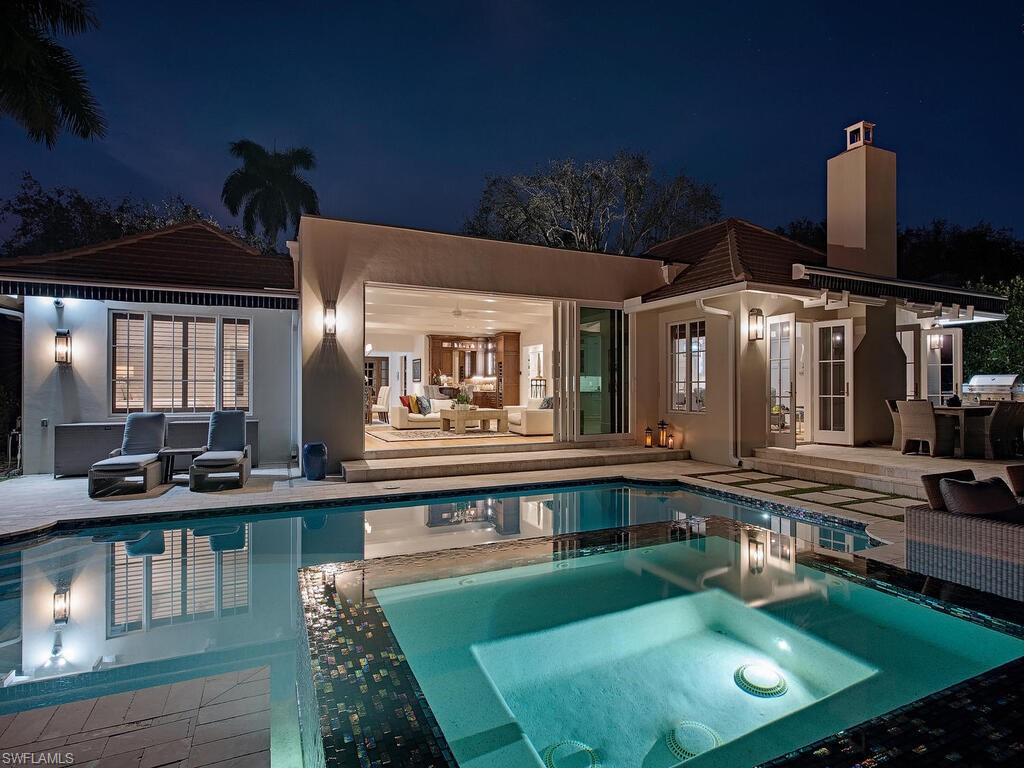 a swimming pool view with a outdoor seating space