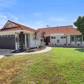 a view of a house with a yard patio and a garden