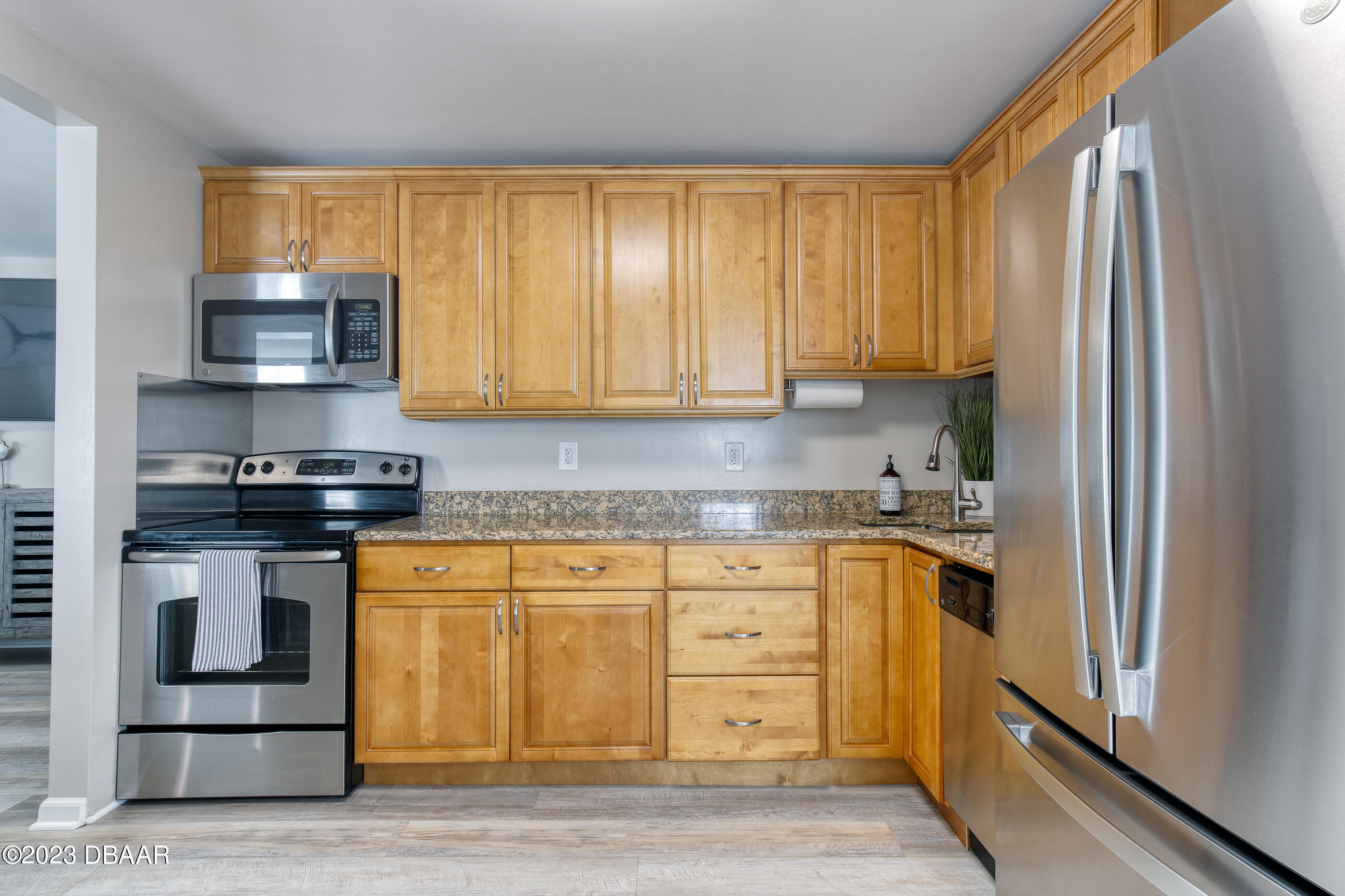103 Roberta Road Ormond Beach, FL 32176 - Photo 11 of 56 a kitchen with stainless steel appliances granite countertop a stove a sink and a refrigerator