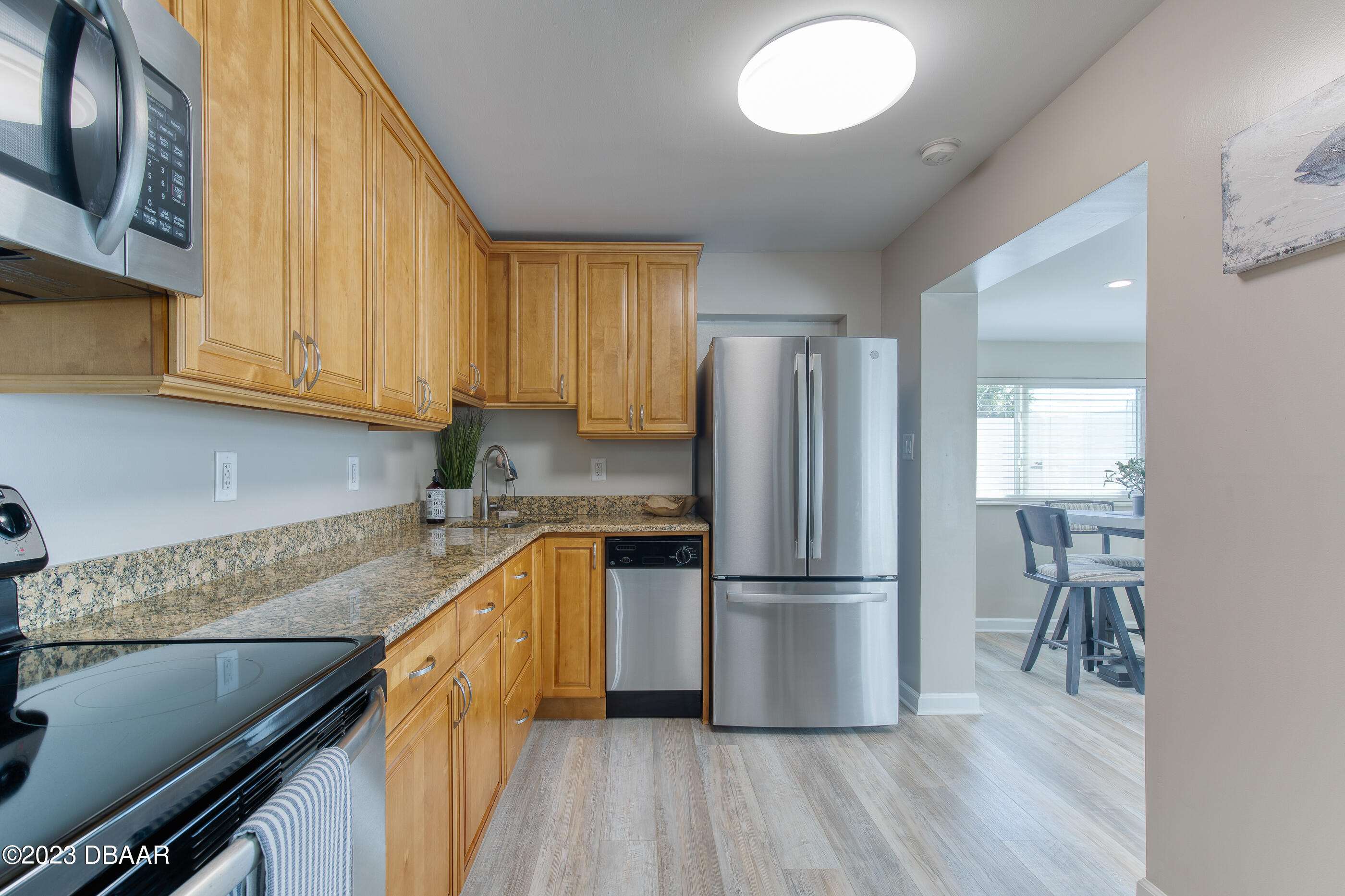 103 Roberta Road Ormond Beach, FL 32176 - Photo 14 of 56 a kitchen with a refrigerator sink and cabinets