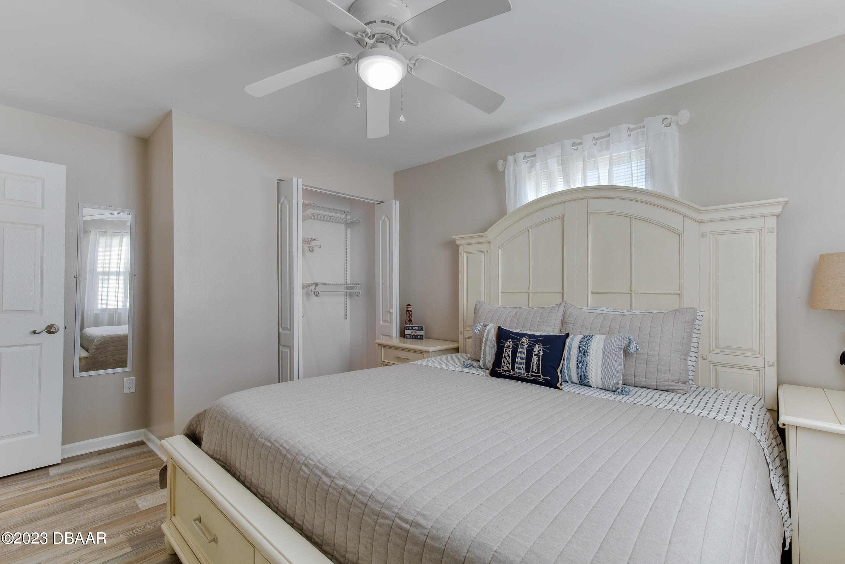 103 Roberta Road Ormond Beach, FL 32176 - Photo 17 of 56 a bedroom with a large bed and a chandelier