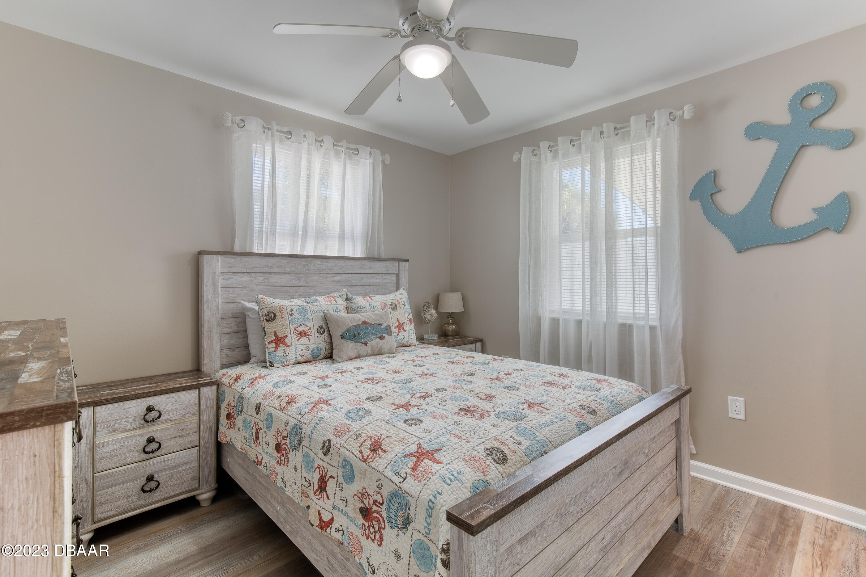 103 Roberta Road Ormond Beach, FL 32176 - Photo 20 of 56 a bedroom with a bed and a chandelier