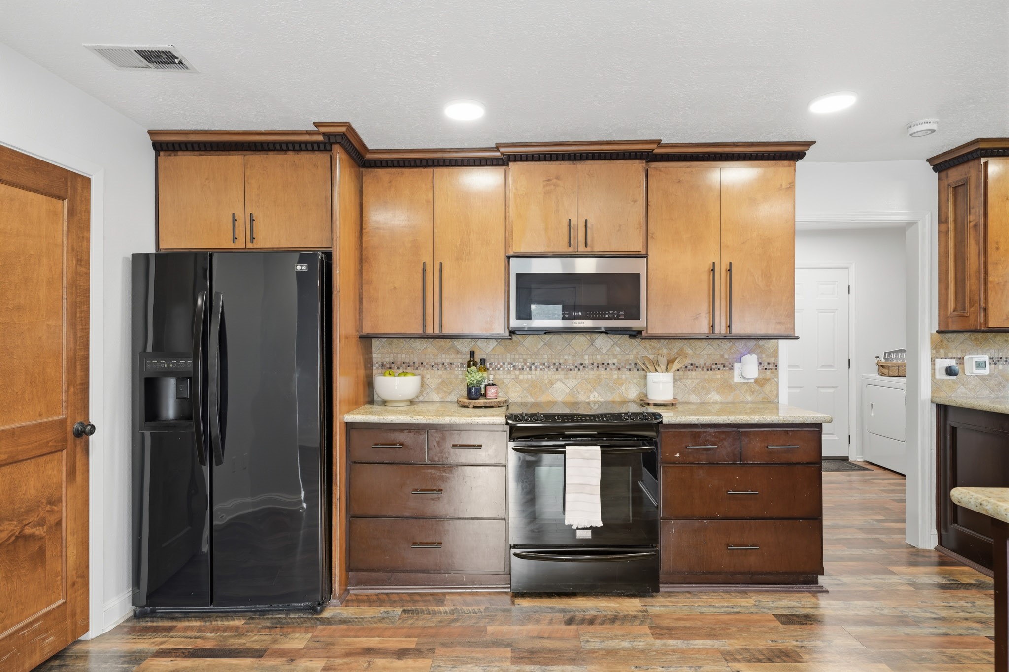 79 Summers Wind Street Conroe, TX 77356 - Photo 13 of 45 a kitchen with a refrigerator and a sink