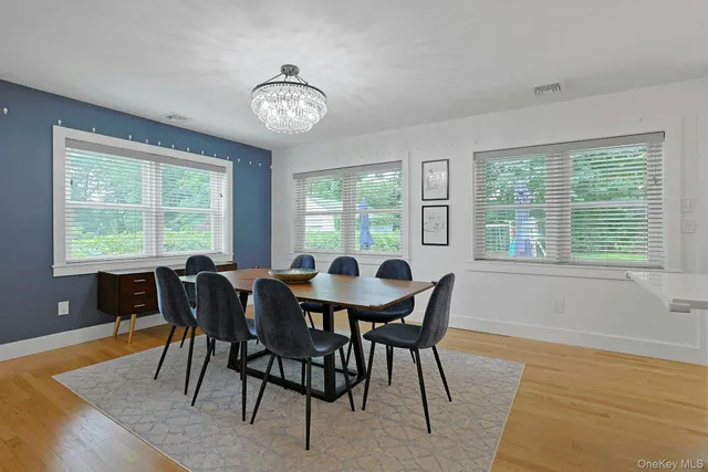 a view of a dining room with furniture windows and wooden floor