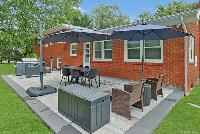 a view of backyard of house with seating space