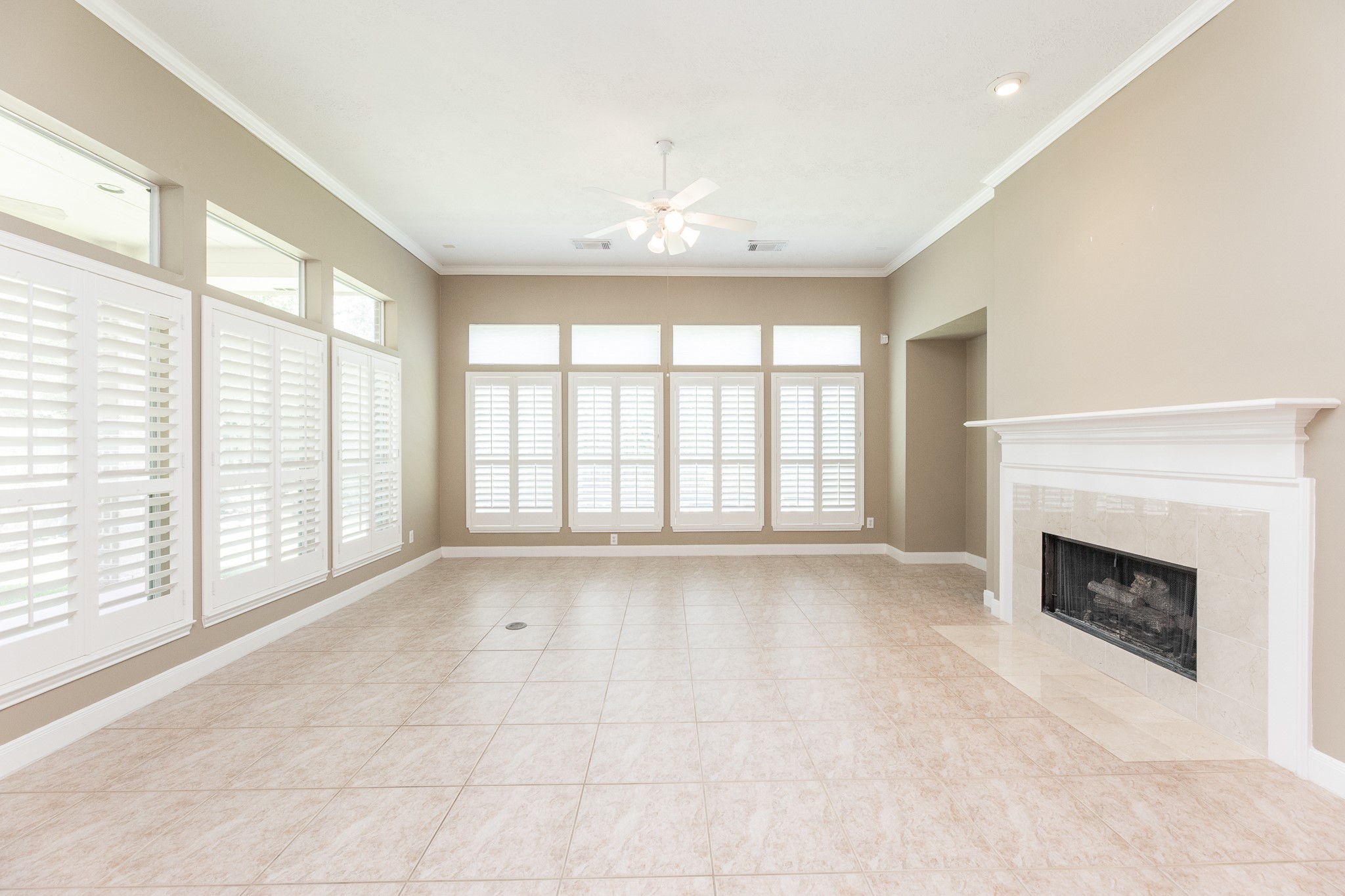 1222 Brinson Court Spring, TX 77379 - Photo 13 of 35 a view of an empty room with windows and a fireplace