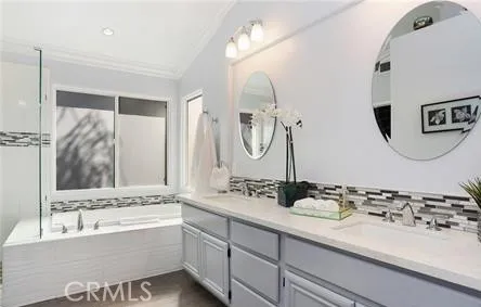 a bathroom with a bathtub sink and mirror