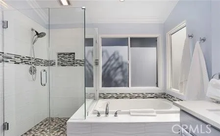 a bathroom with a tub shower and a sink