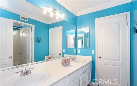 a bathroom with a double vanity sink and a mirror