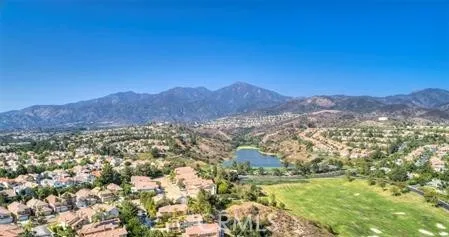 a view of a lush green hillside and houses