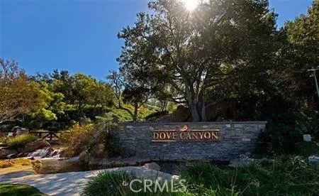 a view of sign board and trees