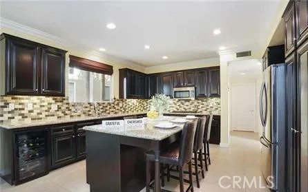 a kitchen with a sink and chairs