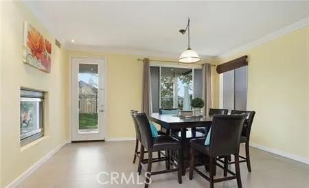 a dining room with furniture window and chandelier