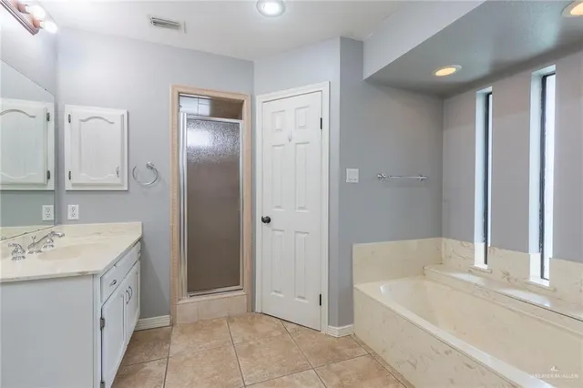 a bathroom with a tub sink and a mirror